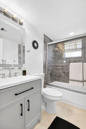 a view of a large living room with a table and chair