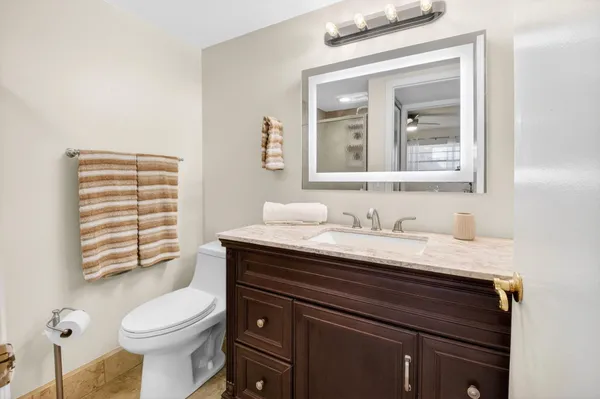 a room with a black white checkered floor with couches and a coffee table