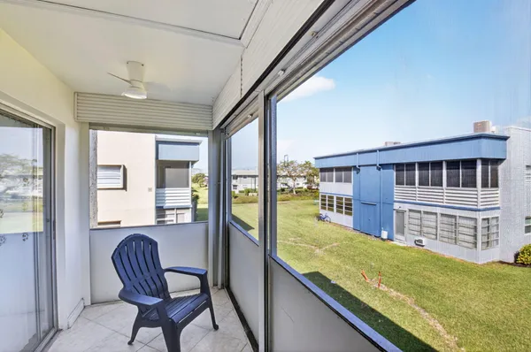 an aerial view of a house with a garden and lake view