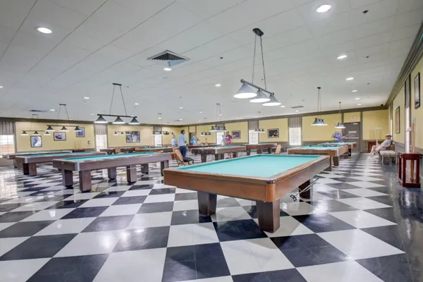 a living room with lots of furniture and a chandelier