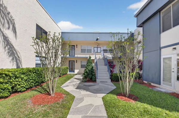 a living room with furniture and a lamp