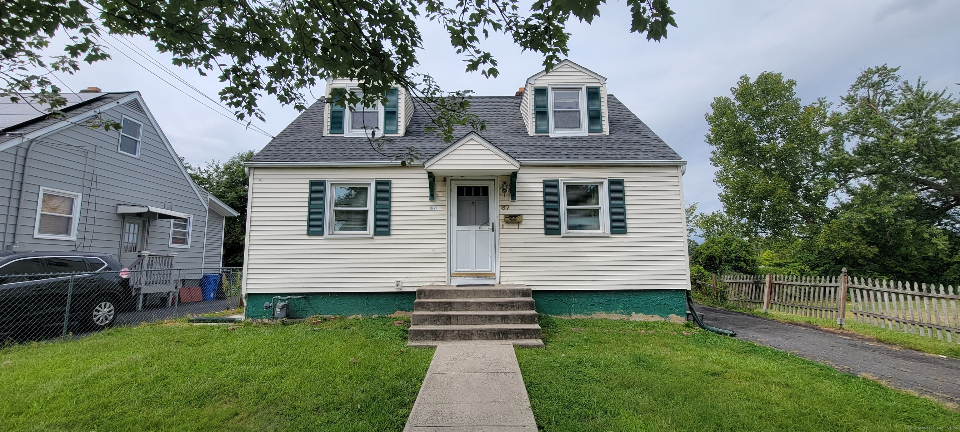 a front view of a house with a garden