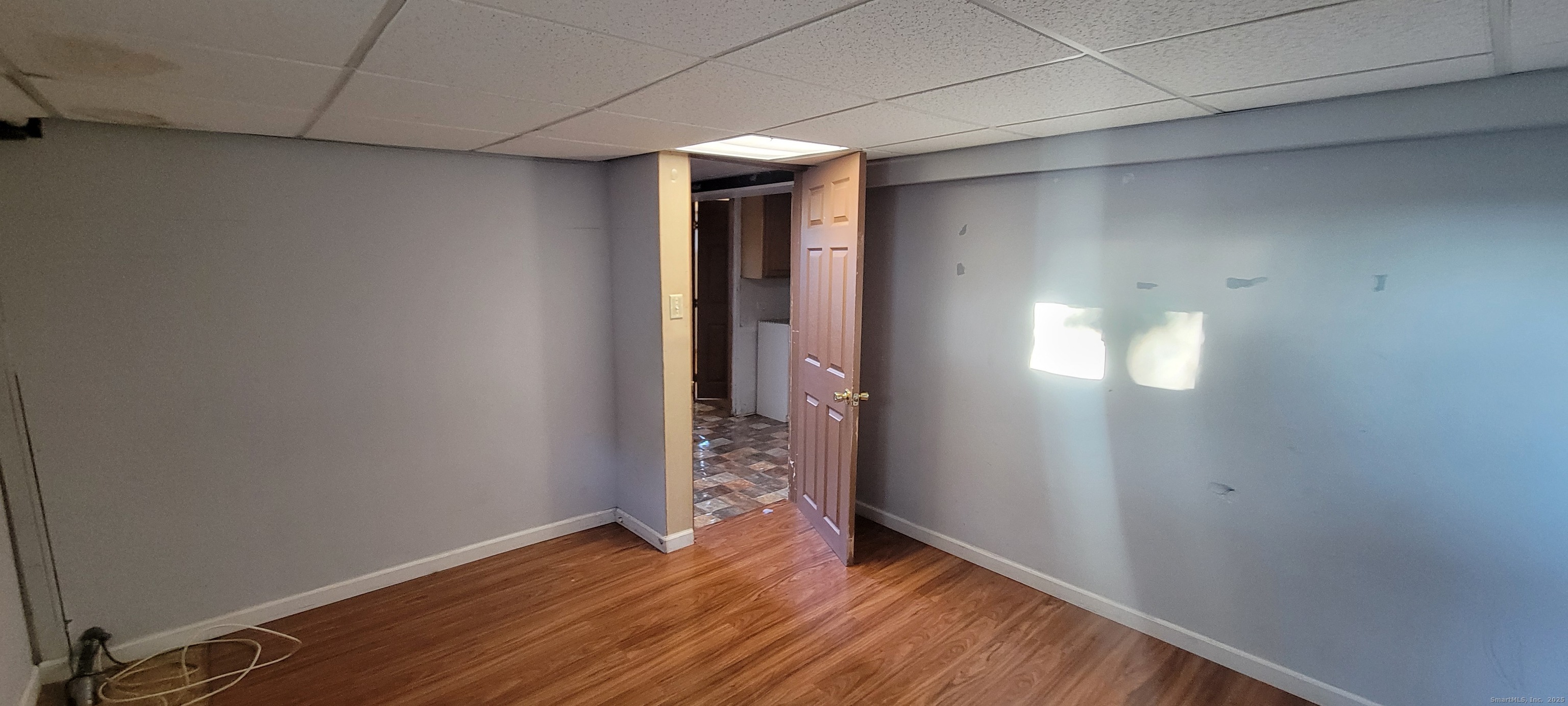 87 Ellington Street Hartford, CT 06106 - Photo 20 of 21 a view of an empty room with wooden floor and a window