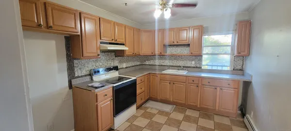 a kitchen with stainless steel appliances granite countertop a sink stove and cabinets