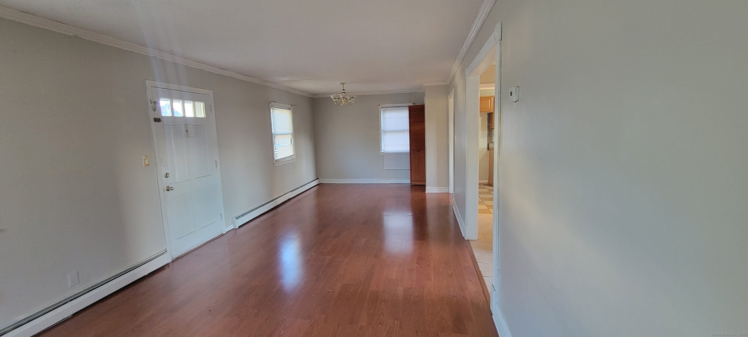 87 Ellington Street Hartford, CT 06106 - Photo 5 of 21 a view of an empty room with wooden floor and a window