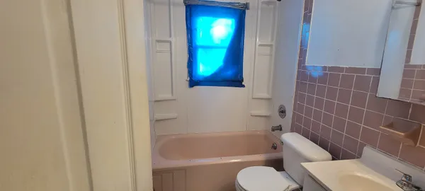 a bathroom with a bath tub and toilet