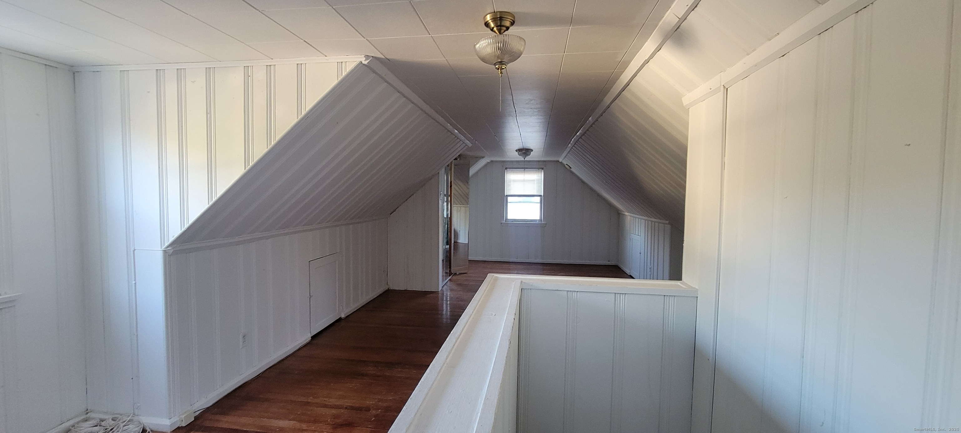 87 Ellington Street Hartford, CT 06106 - Photo 9 of 21 a view of a hallway with wooden floor and staircase