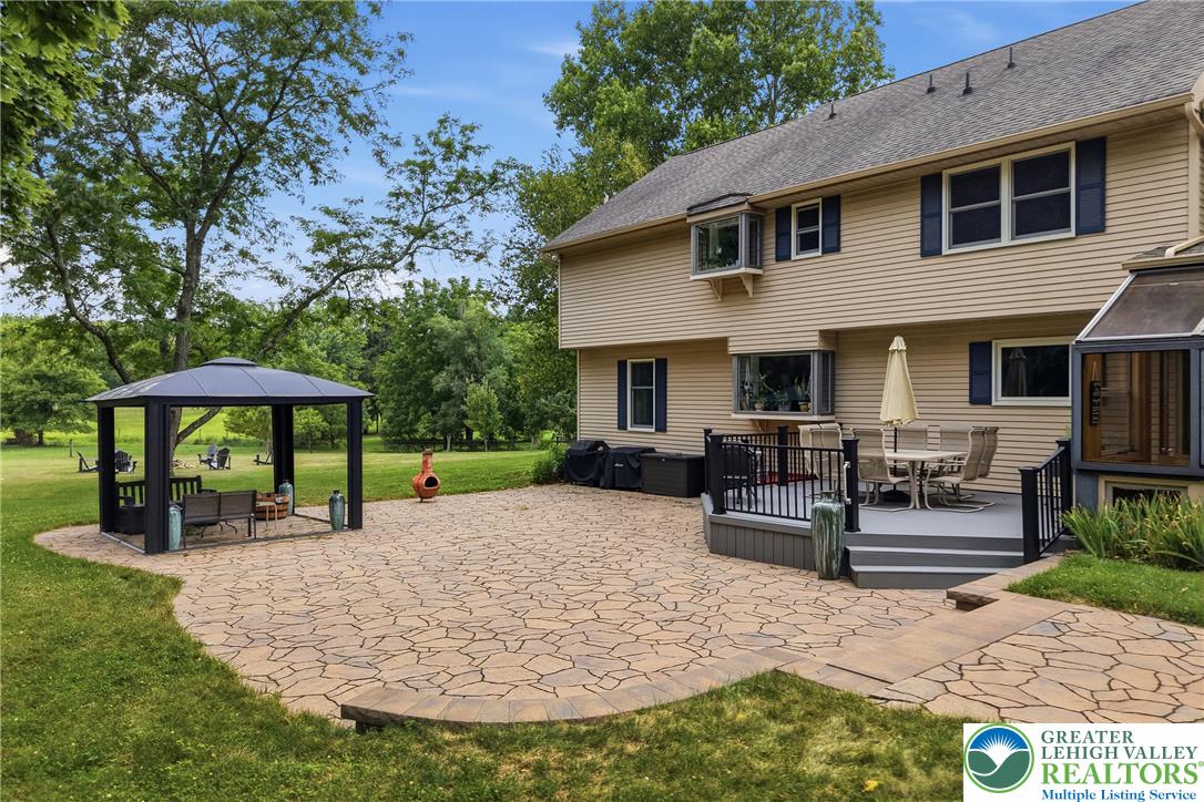 1553 Surrey Road Bethlehem, PA 18015 - Photo 66 of 92 An inviting backyard oasis offers a spacious patio, a relaxing gazebo, and a charming deck for outdoor living.