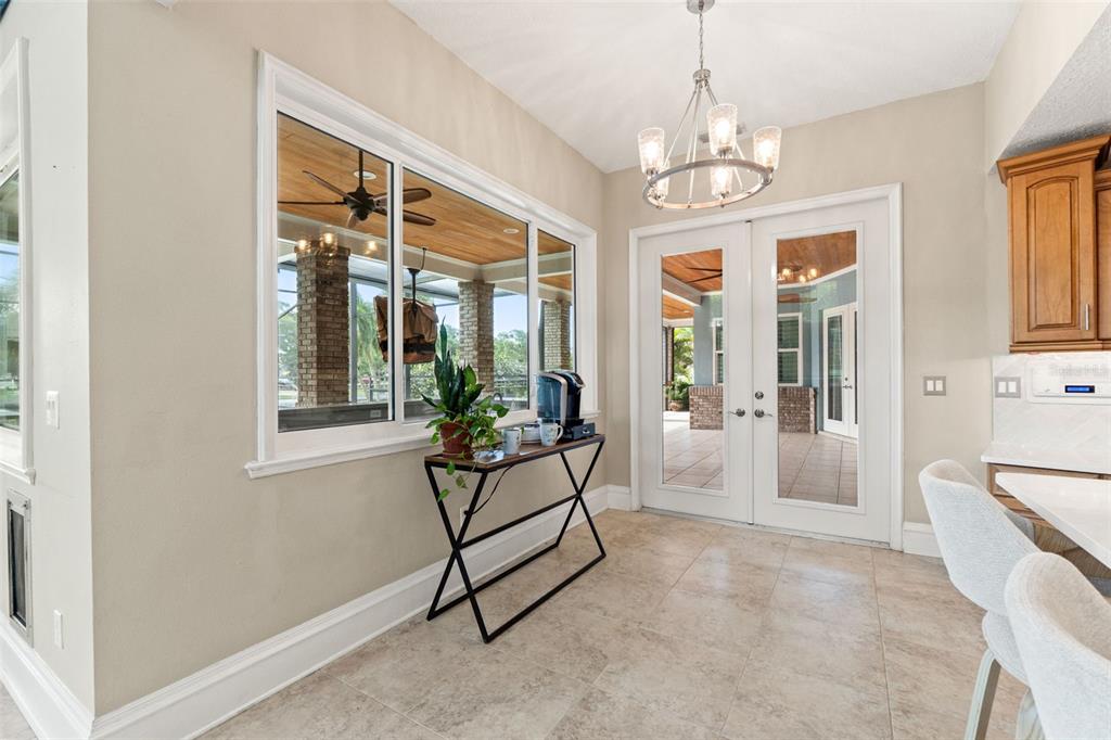 6936 River Road New Port Richey, FL 34652 - Photo 59 of 93 a living room with furniture and a chandelier