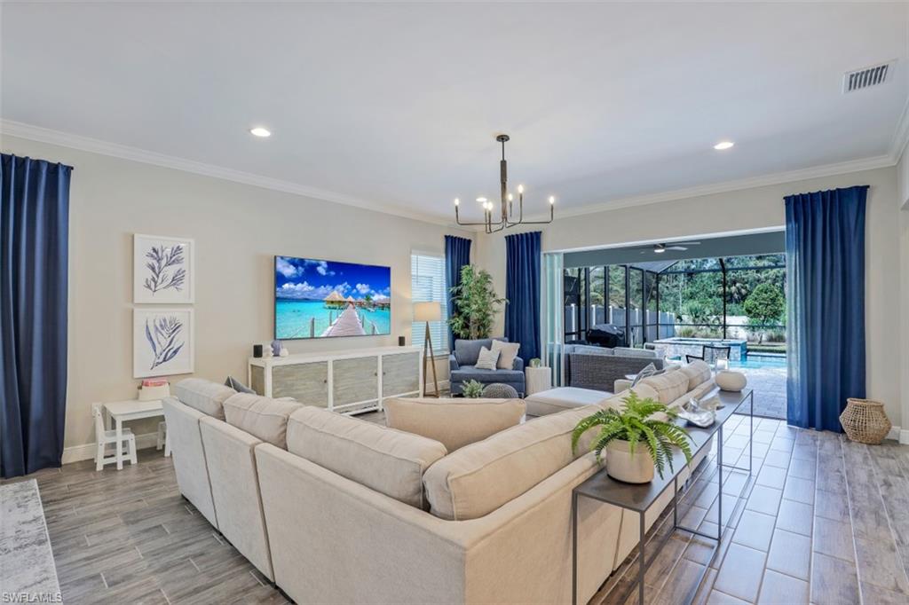 3528 Pilot Circle Naples, FL 34120 - Photo 12 of 46 a living room with furniture and a flat screen tv