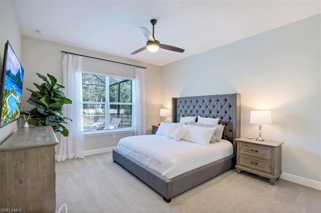 3528 Pilot Circle Naples, FL 34120 - Photo 24 of 46 a bedroom with a large bed and a potted plant