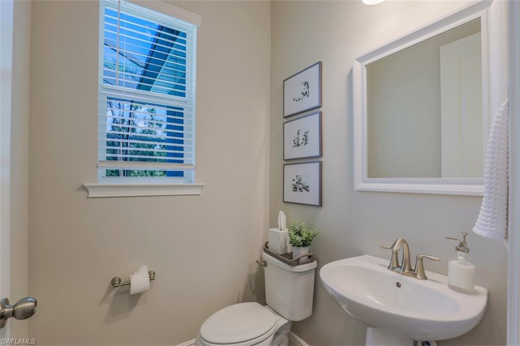 3528 Pilot Circle Naples, FL 34120 - Photo 25 of 46 a bathroom with a toilet sink and mirror