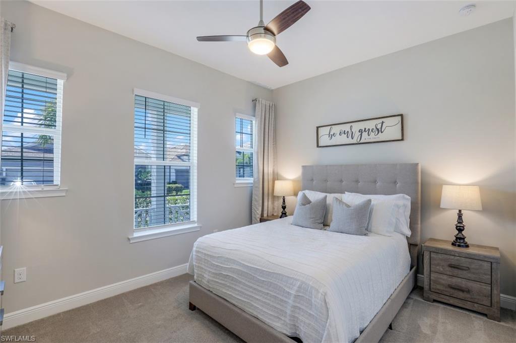 3528 Pilot Circle Naples, FL 34120 - Photo 26 of 46 a bedroom with a large bed and a chandelier