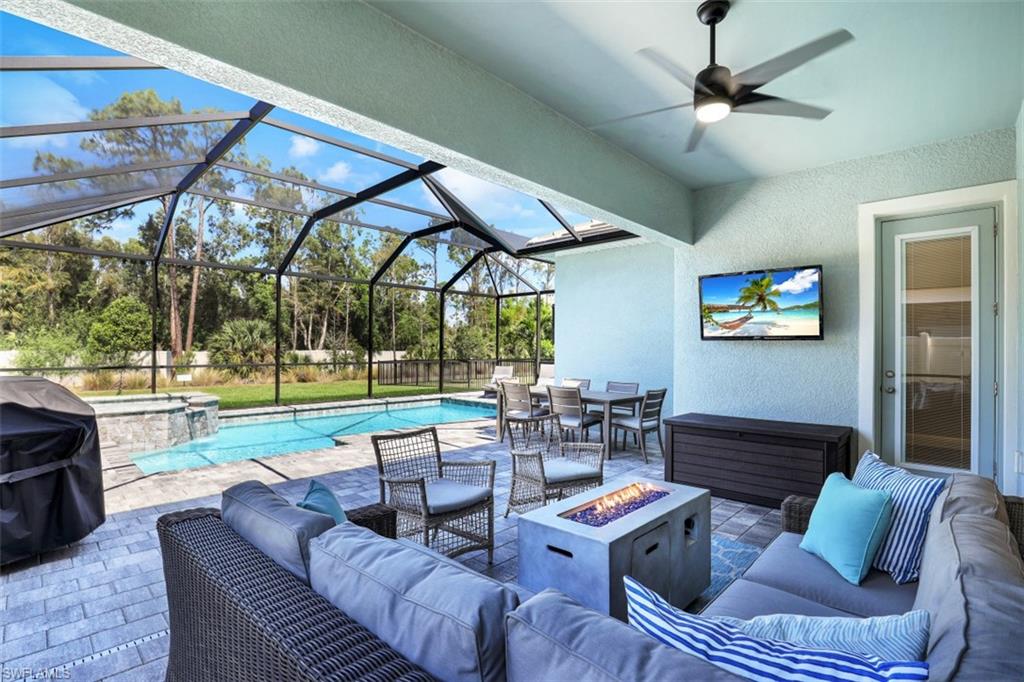 3528 Pilot Circle Naples, FL 34120 - Photo 31 of 46 a living room with patio furniture and a floor to ceiling window