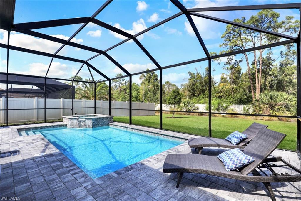 3528 Pilot Circle Naples, FL 34120 - Photo 32 of 46 a living room with furniture and a floor to ceiling window
