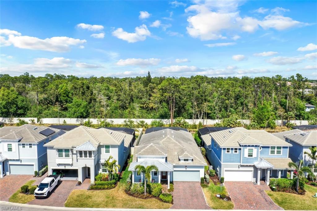 3528 Pilot Circle Naples, FL 34120 - Photo 44 of 46 a front view of a residential apartment building with a yard