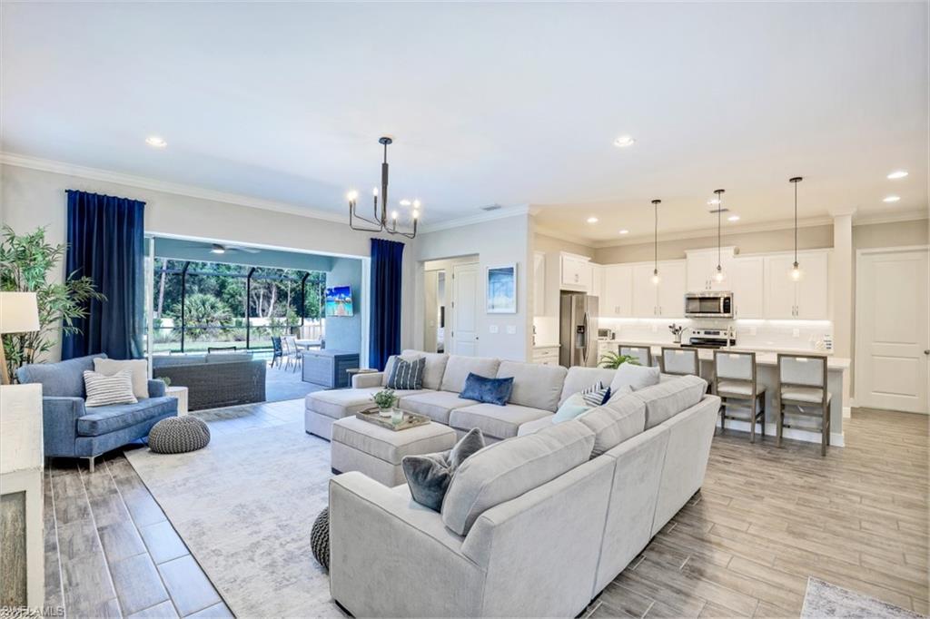 3528 Pilot Circle Naples, FL 34120 - Photo 8 of 46 a living room with furniture and a large window