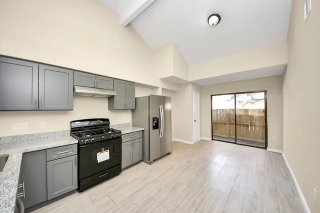 a kitchen with stainless steel appliances granite countertop a stove and a refrigerator