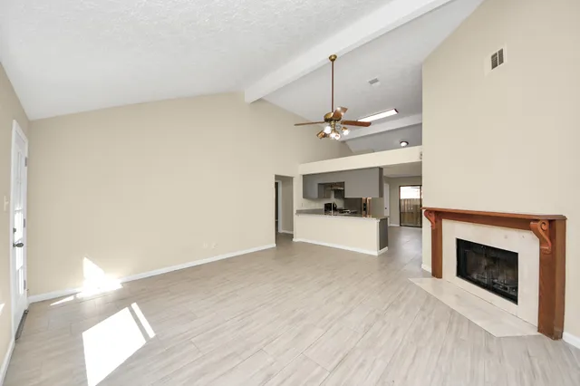 a view of a livingroom with a fireplace and cabinet