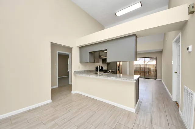 a view of living room with kitchen island stainless steel appliances wooden floor and living room view