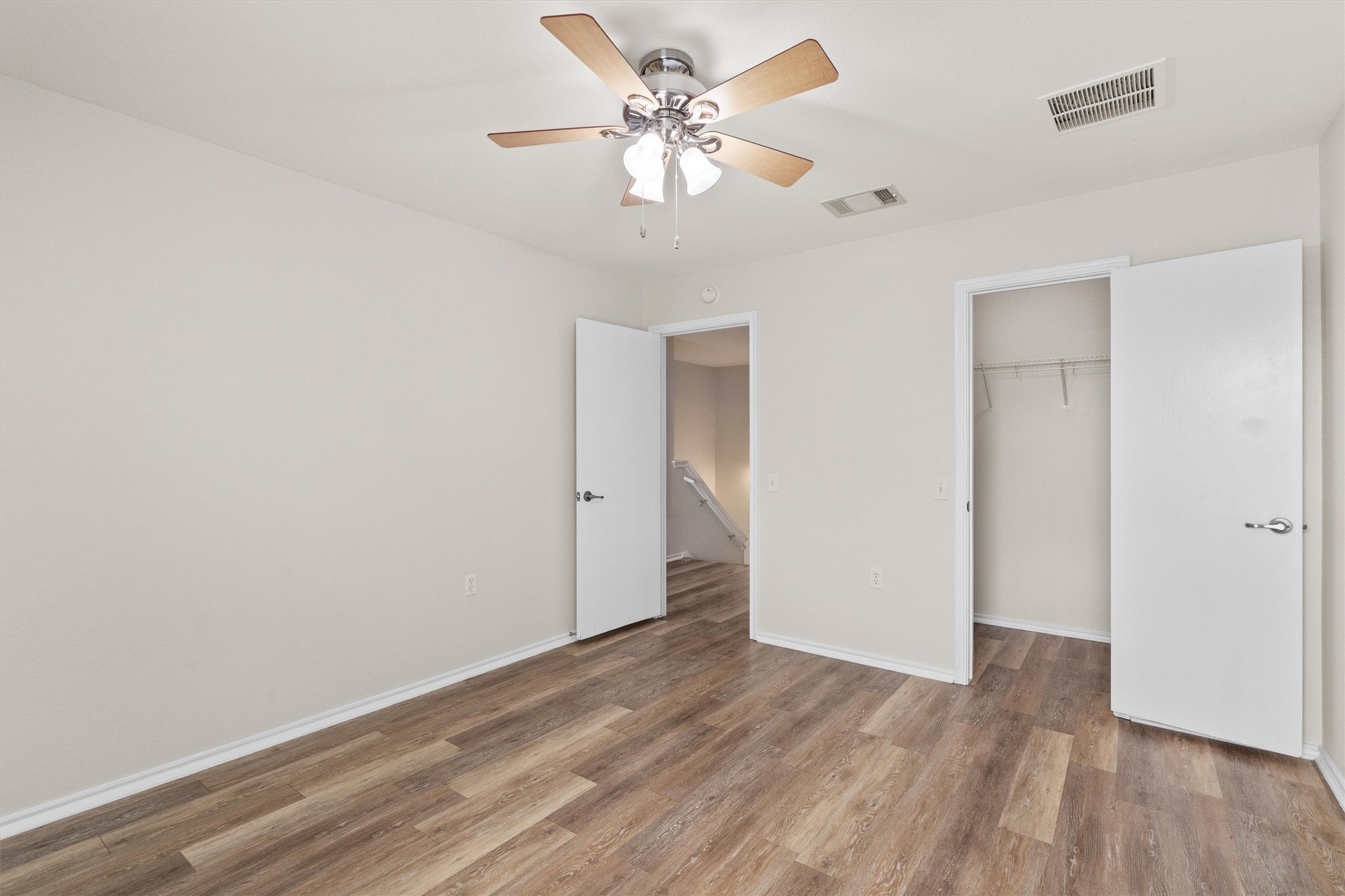 5825 Silver Screen Drive Austin, TX 78747 - Photo 20 of 40 Comfortable room features wood flooring and a refreshing ceiling fan.