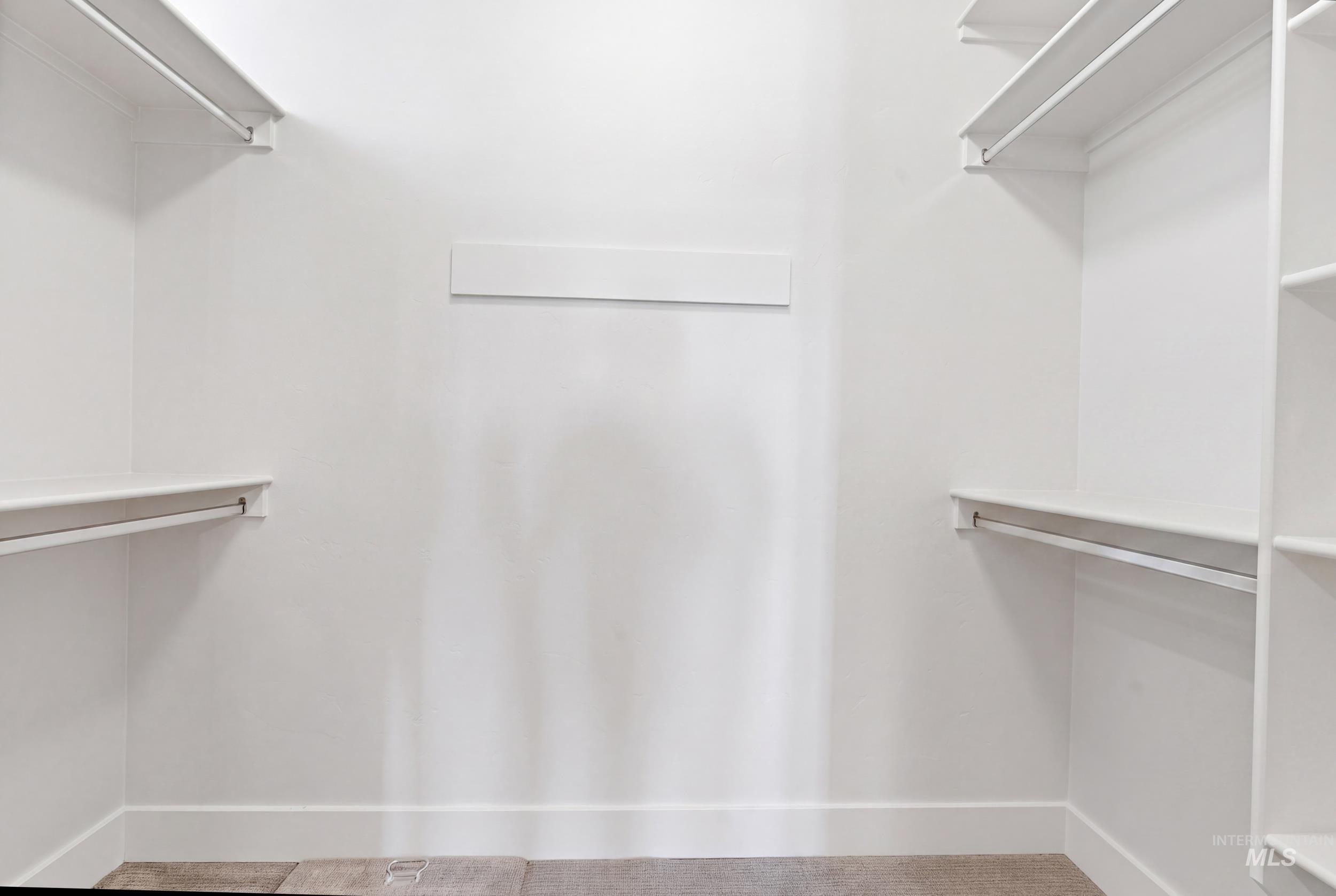 6347 South Utmost Lane Meridian, ID 83642 - Photo 18 of 37 Walk-in closet featuring white built-in shelving, hanging rods, and light-toned flooring