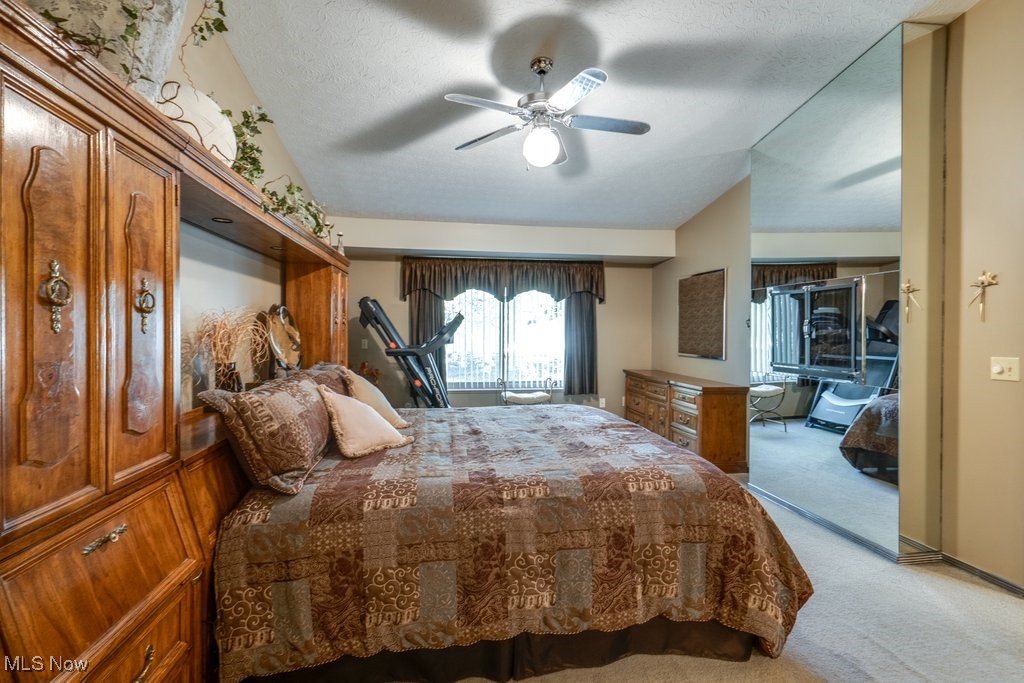 3404 South Smith Road Fairlawn, OH 44333 - Photo 23 of 37 Bedroom featuring carpet flooring, a ceiling fan, and a textured ceiling