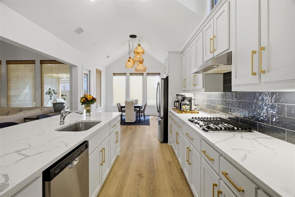 6033 Strada Cove Fort Worth, TX 76123 - Photo 12 of 35 a kitchen with stove a sink and cabinets
