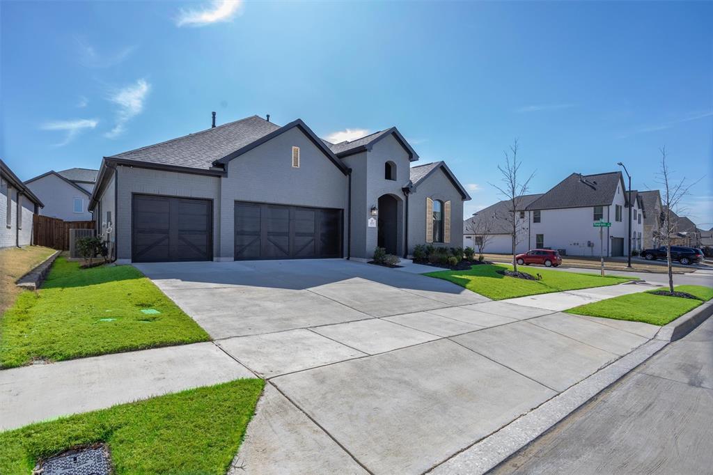 6033 Strada Cove Fort Worth, TX 76123 - Photo 2 of 35 a front view of a house with a yard and garage