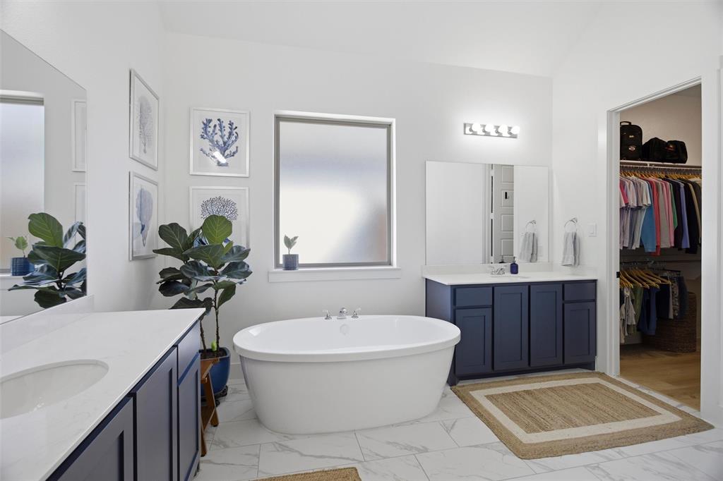 6033 Strada Cove Fort Worth, TX 76123 - Photo 21 of 35 a bathroom with a tub sink and mirror