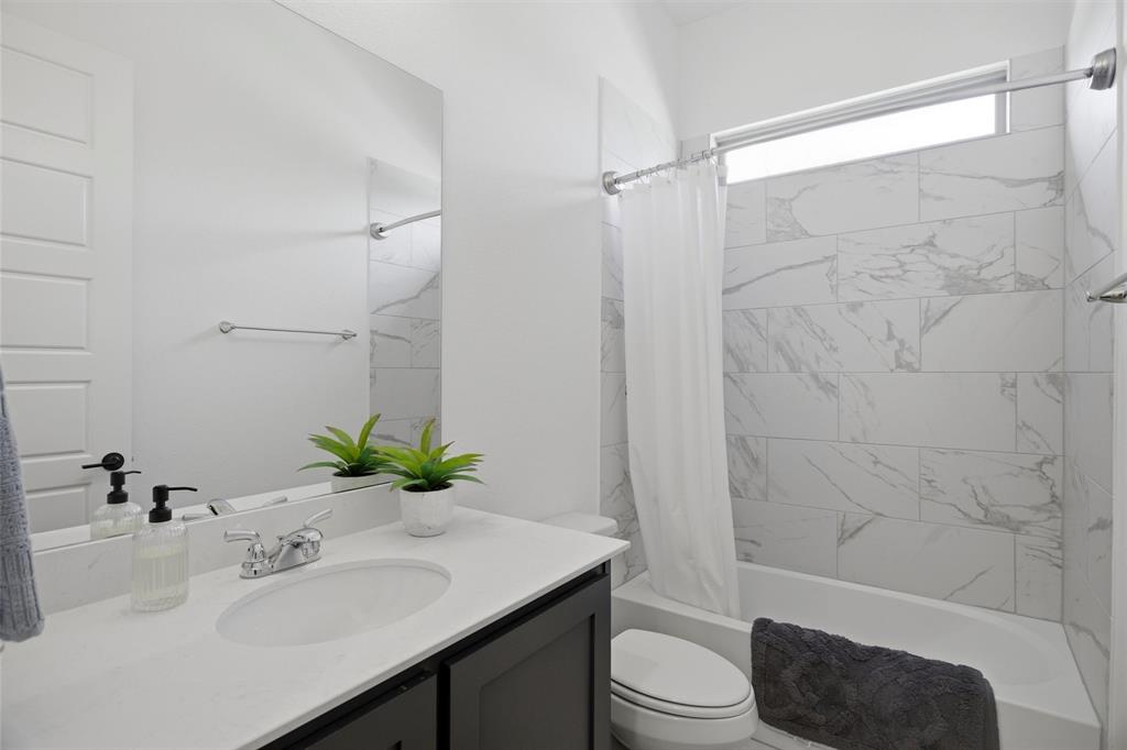 6033 Strada Cove Fort Worth, TX 76123 - Photo 24 of 35 a bathroom with a sink toilet and shower