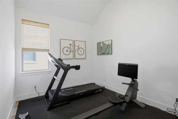 a room with gym equipment and windows