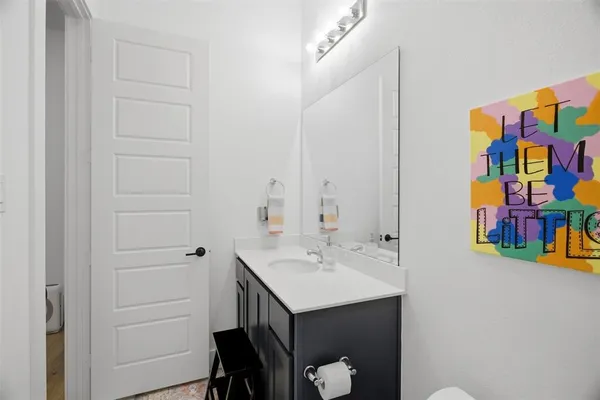 a bathroom with a sink mirror and vanity