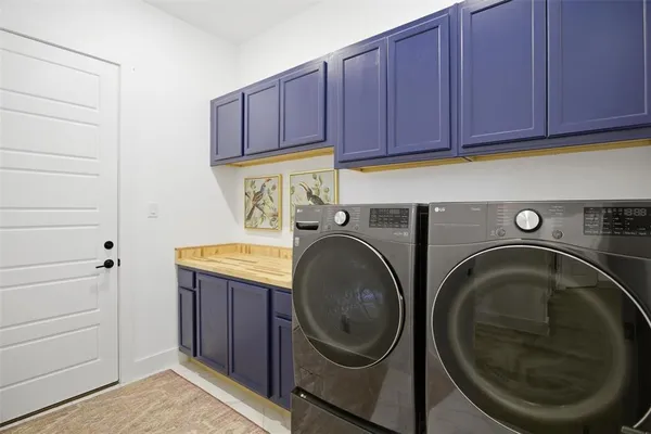 a utility room with sink dryer and washer