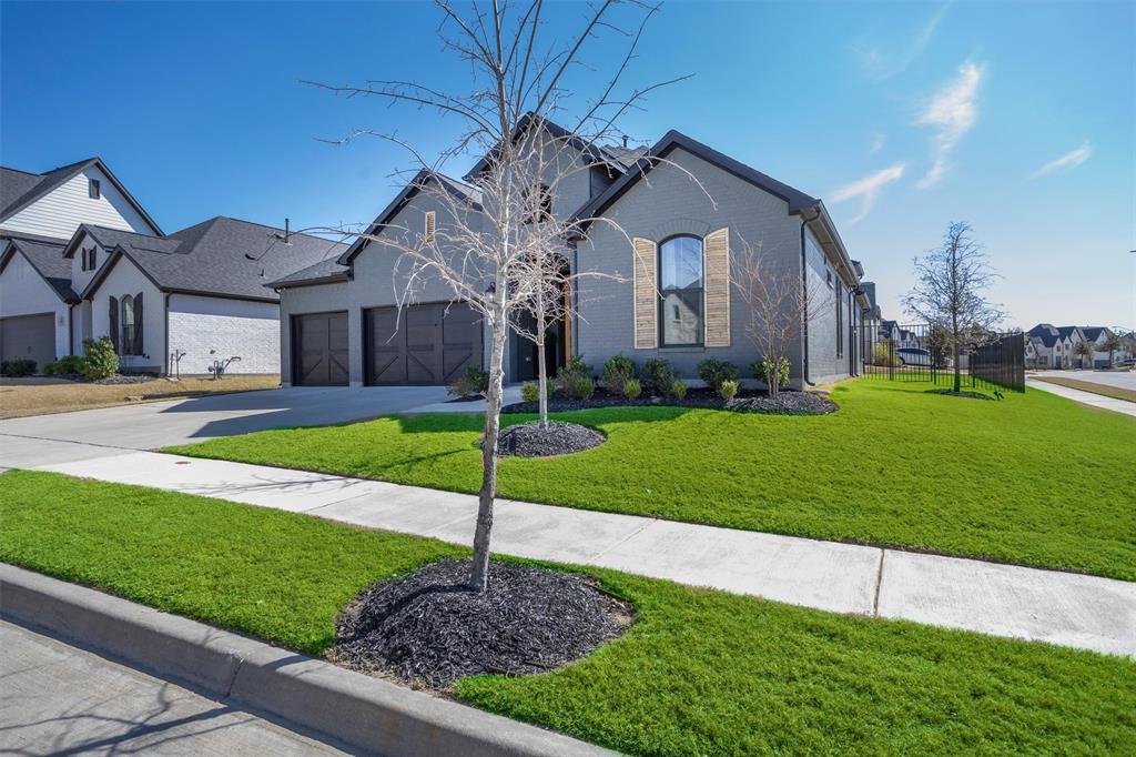 6033 Strada Cove Fort Worth, TX 76123 - Photo 3 of 35 a front view of house with a yard