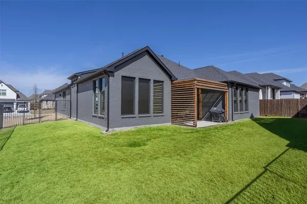 a view of a house with a yard and pathway