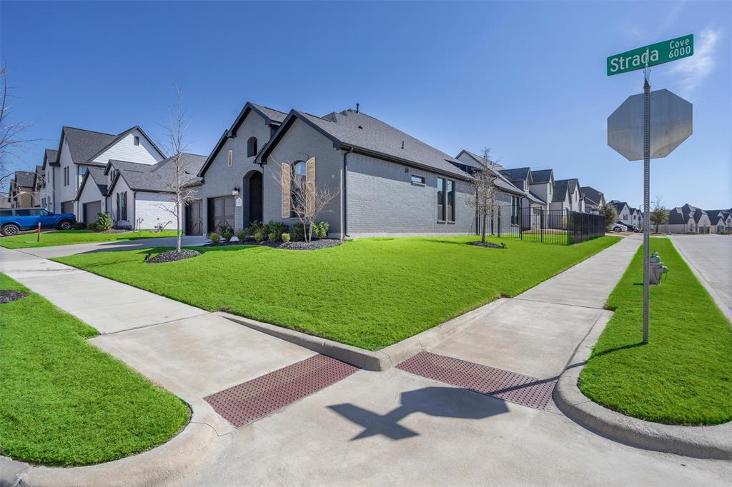 6033 Strada Cove Fort Worth, TX 76123 - Photo 4 of 35 a view of a big house with a big yard and potted plants