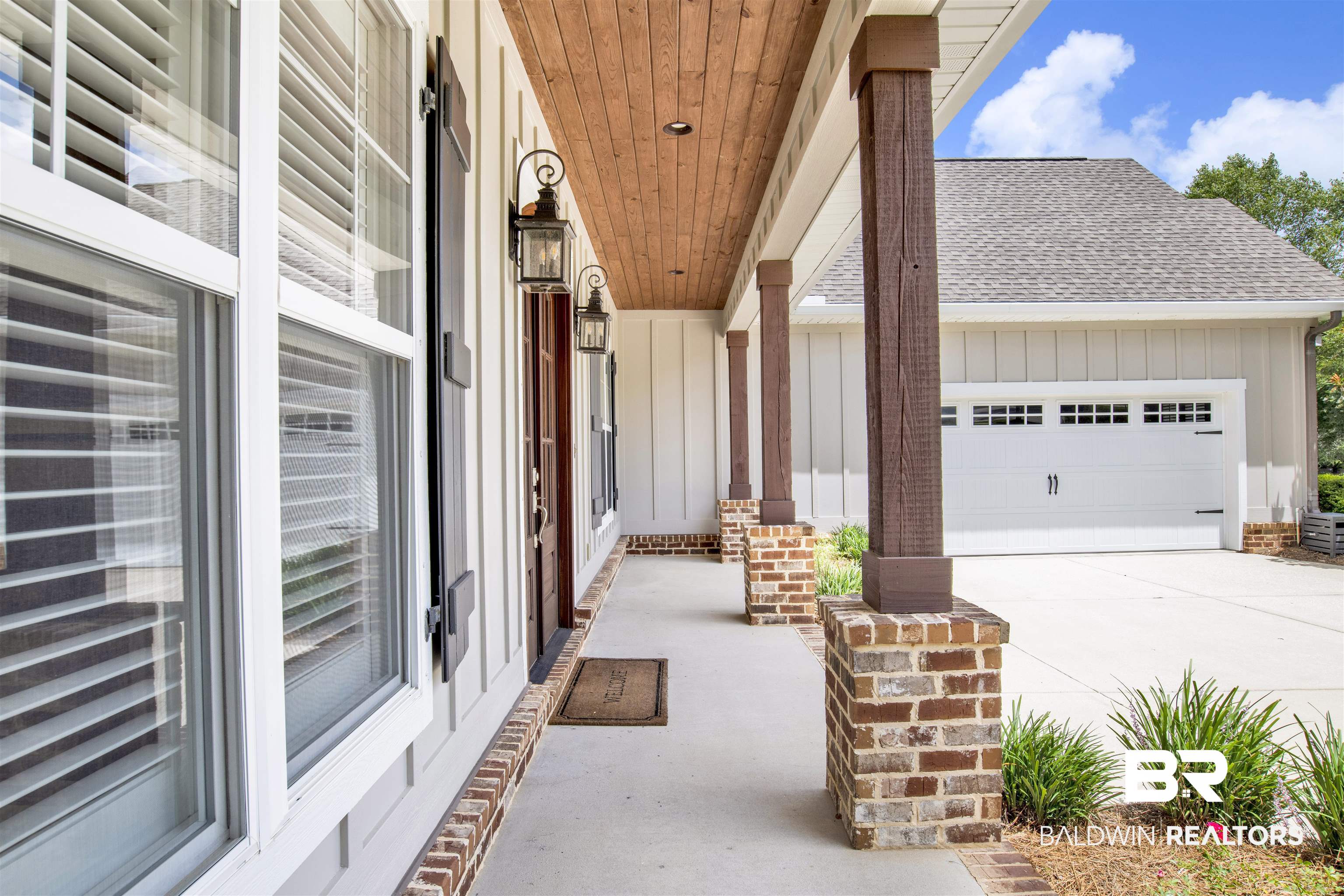 131 Sedgefield Avenue Fairhope, AL 36532 - Photo 7 of 50 Exterior space featuring a garage, a porch, and central AC unit