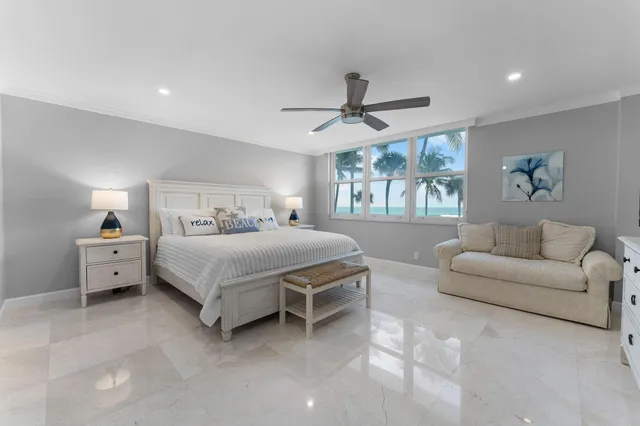 a spacious bedroom with a bed a couch and a window