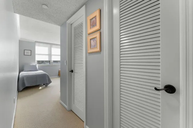 a bedroom with two beds and a large window