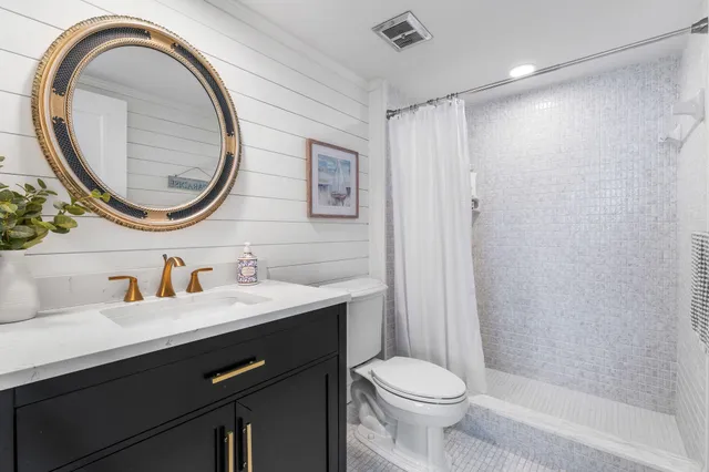 a bathroom with a toilet a sink and a mirror