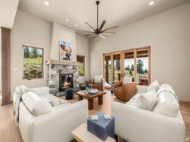 22677 East Snowbird Drive, Unit 47 Helper, UT 84526 - Photo 7 of 43 Living area featuring light wood-style flooring, a high ceiling, a fireplace, a ceiling fan, and recessed lighting