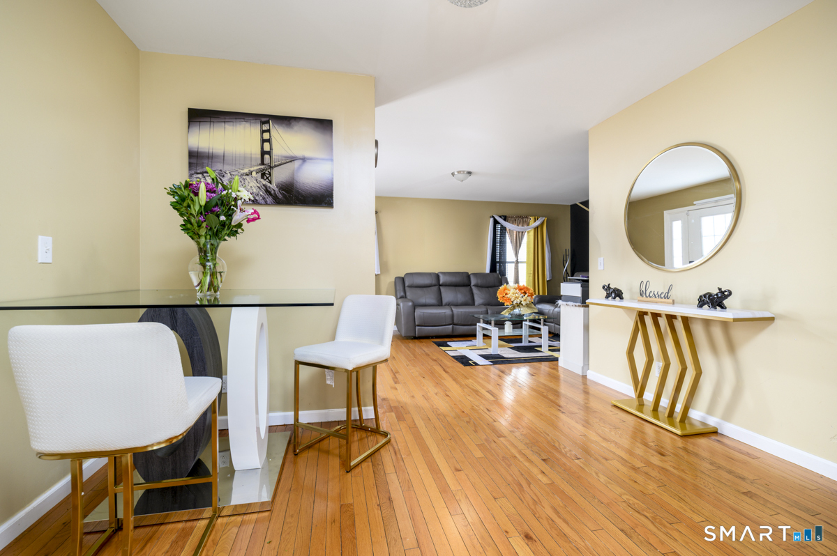 800 Seaview Avenue, Unit 8001 Bridgeport, CT 06607 - Photo 11 of 25 a living room with furniture and a wooden floor