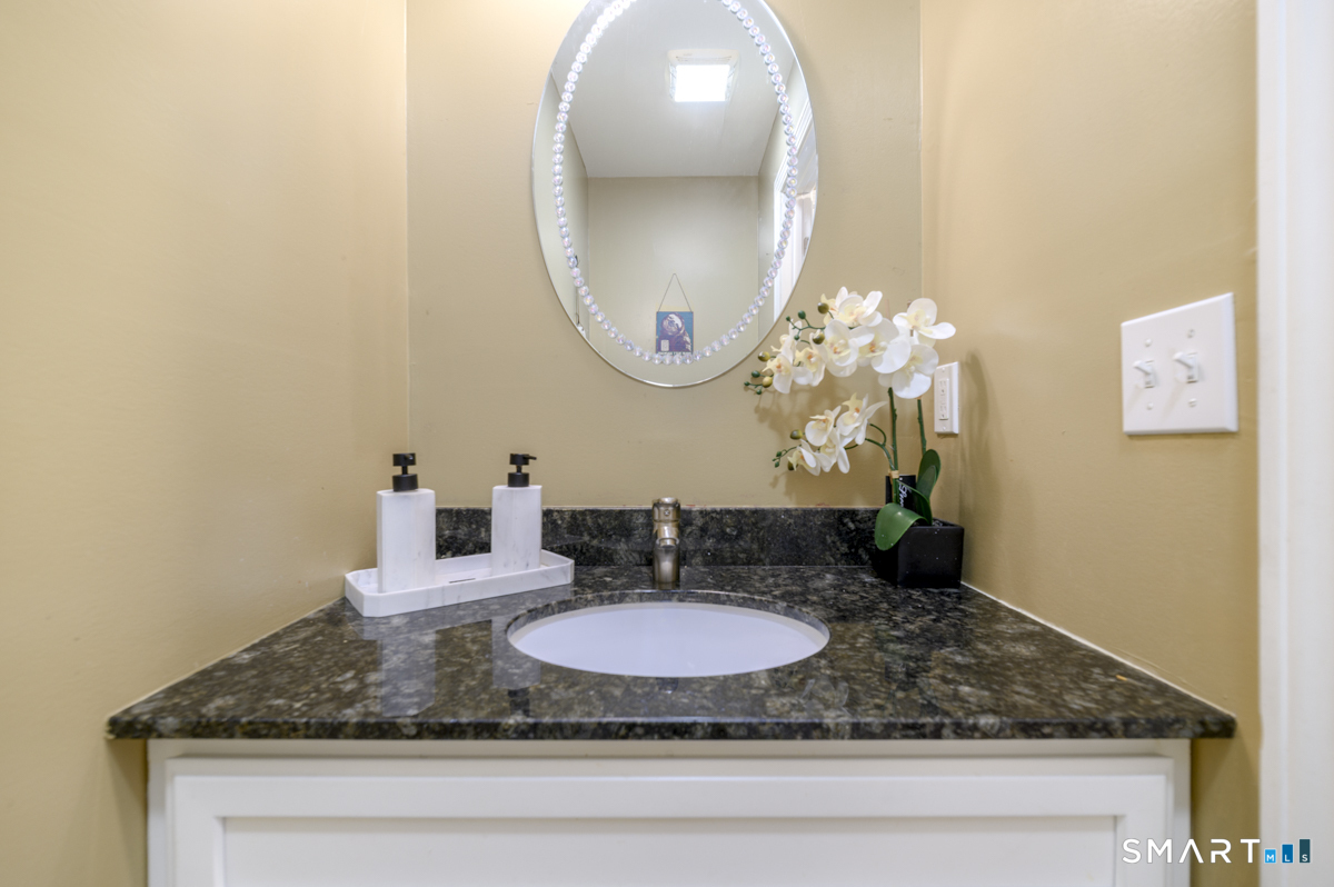 800 Seaview Avenue, Unit 8001 Bridgeport, CT 06607 - Photo 13 of 25 a bathroom with a granite countertop sink and a mirror