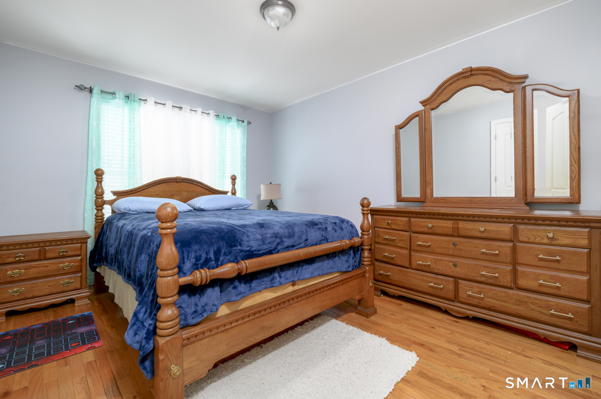 800 Seaview Avenue, Unit 8001 Bridgeport, CT 06607 - Photo 14 of 25 a bedroom with a bed and a dresser
