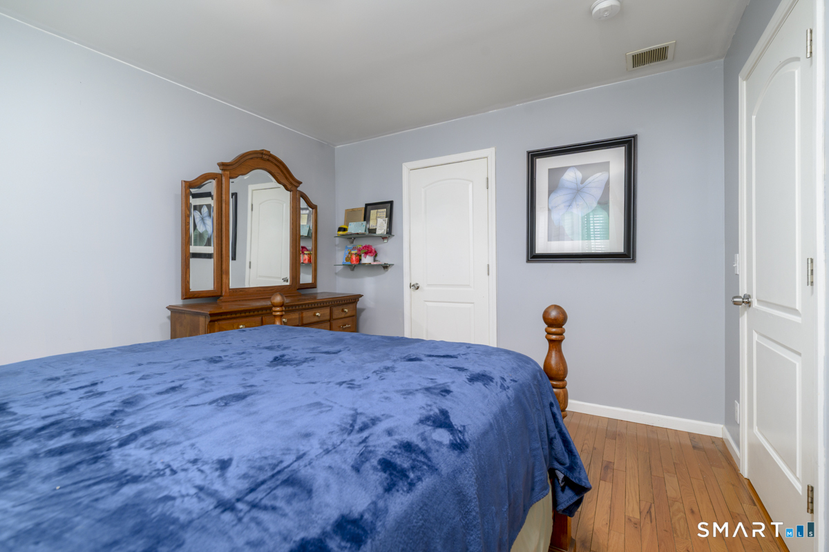 800 Seaview Avenue, Unit 8001 Bridgeport, CT 06607 - Photo 15 of 25 a bedroom with a bed and a dresser in it