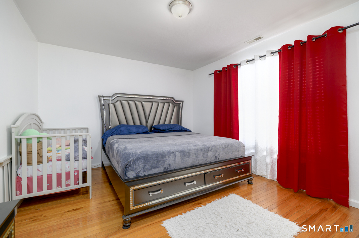 800 Seaview Avenue, Unit 8001 Bridgeport, CT 06607 - Photo 17 of 25 a bed sitting in a bedroom next to a window