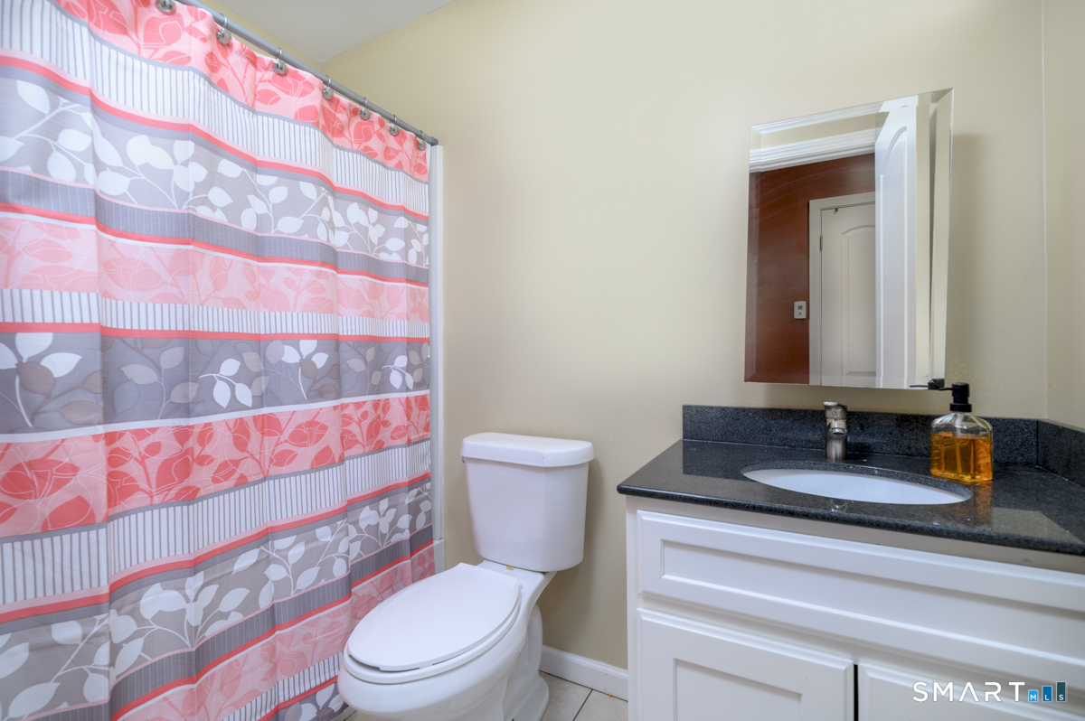 800 Seaview Avenue, Unit 8001 Bridgeport, CT 06607 - Photo 20 of 25 a bathroom with a toilet sink and mirror