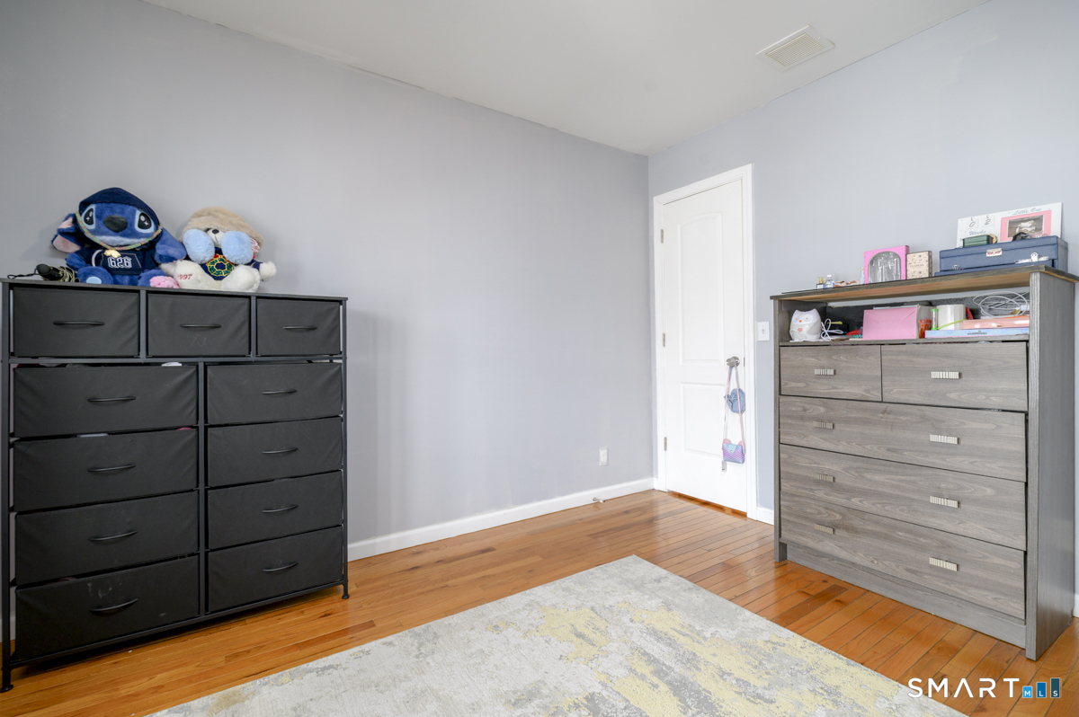 800 Seaview Avenue, Unit 8001 Bridgeport, CT 06607 - Photo 5 of 25 a bed room with a bed and a dresser
