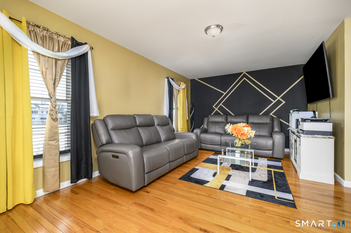 800 Seaview Avenue, Unit 8001 Bridgeport, CT 06607 - Photo 7 of 25 a living room with furniture and a flat screen tv